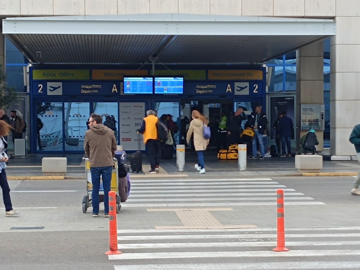 Traveler meeting In Town Check In agent outside Athens International Airport ATH departures terminal for luggage delivery