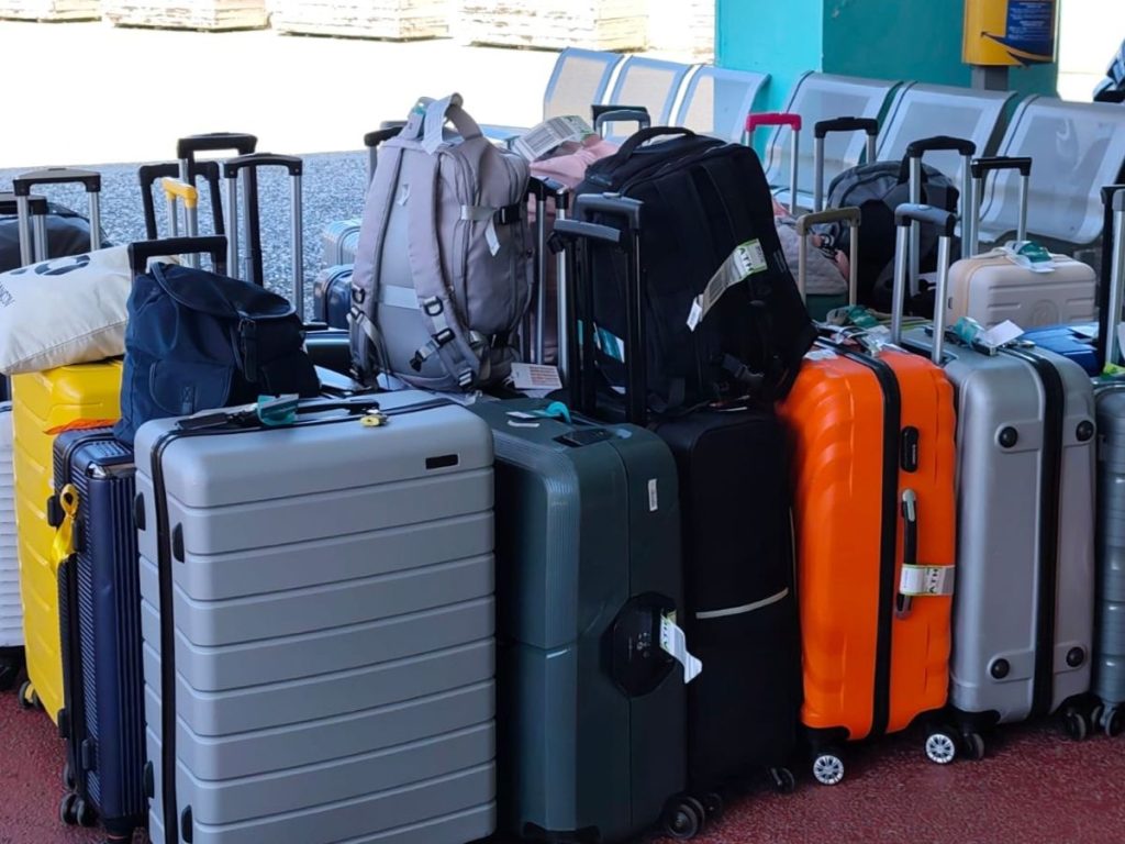 Collection of traveler suitcases and backpacks secured for Athens luggage storage and airport transfer