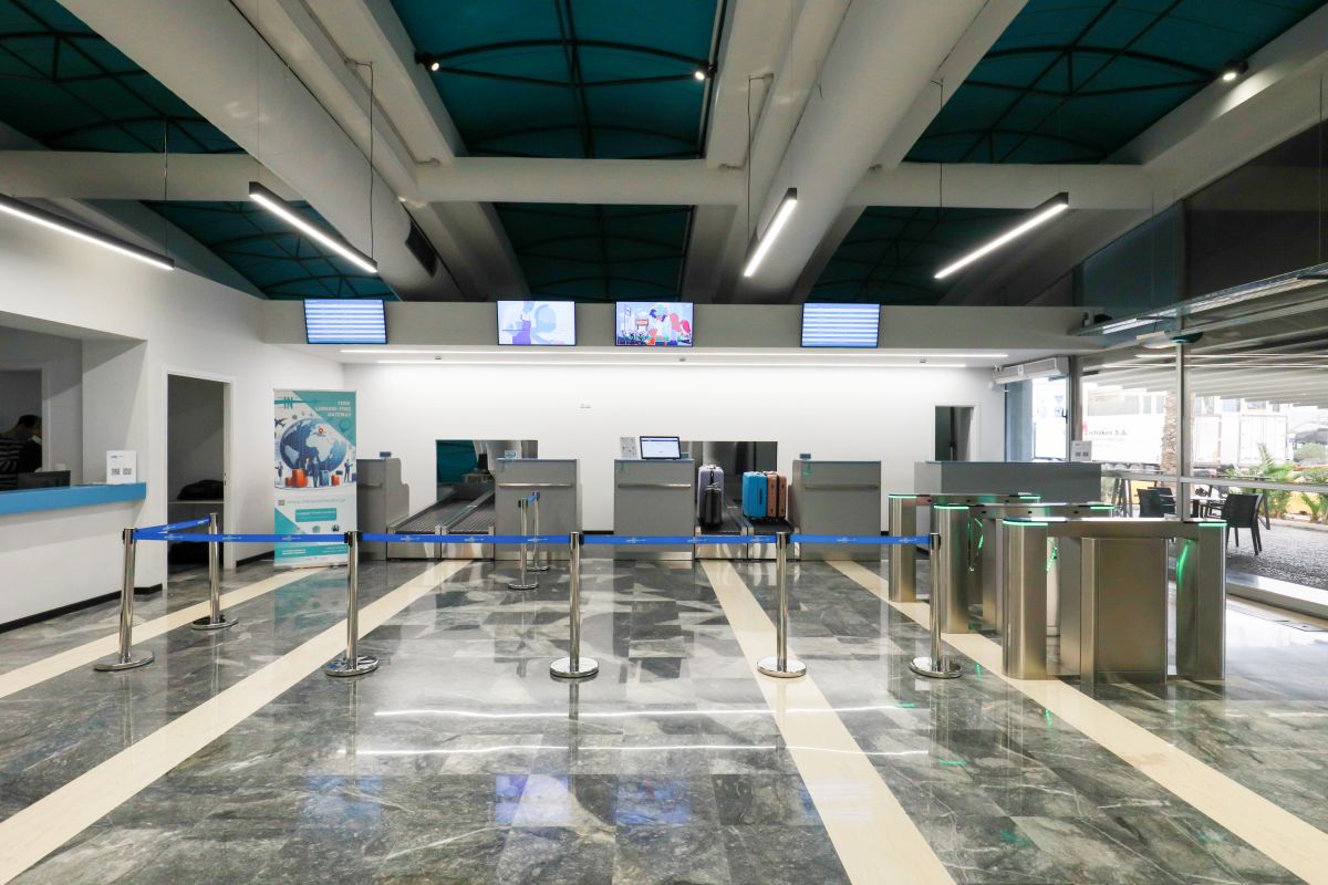 In Town Check In luggage storage terminal interior with check-in counters and baggage belts in Piraeus Gate E3